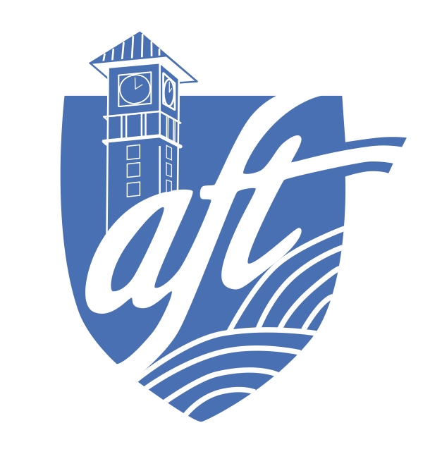 AFT-Y logo, showing the blue "AFT" shield with a stylized representation of the YVC clock tower in the background. 